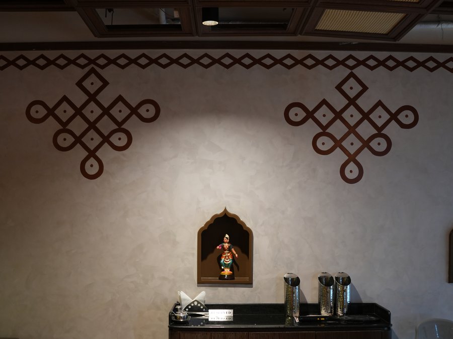 Kolam motifs and an arched niche above the service station